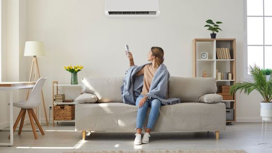 woman site in house under her AC