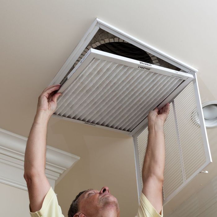 Man changes AC air filter