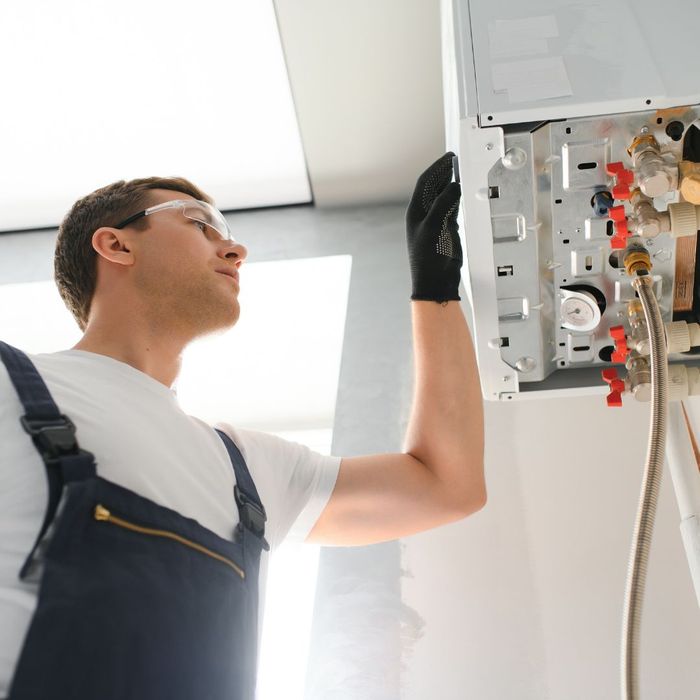 HVAC tech inspecting a system