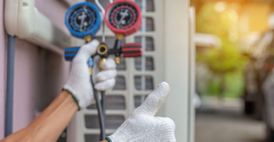 AC contractor checking an AC unit