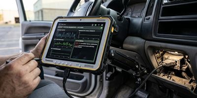 Rugged diagnostic tablet mounted inside a vehicle dashboard