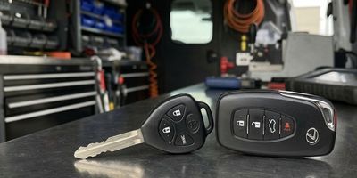 Toyota car key remote and Lexus key fob on workbench