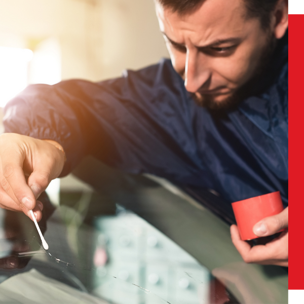 technician fixing crack on windshield