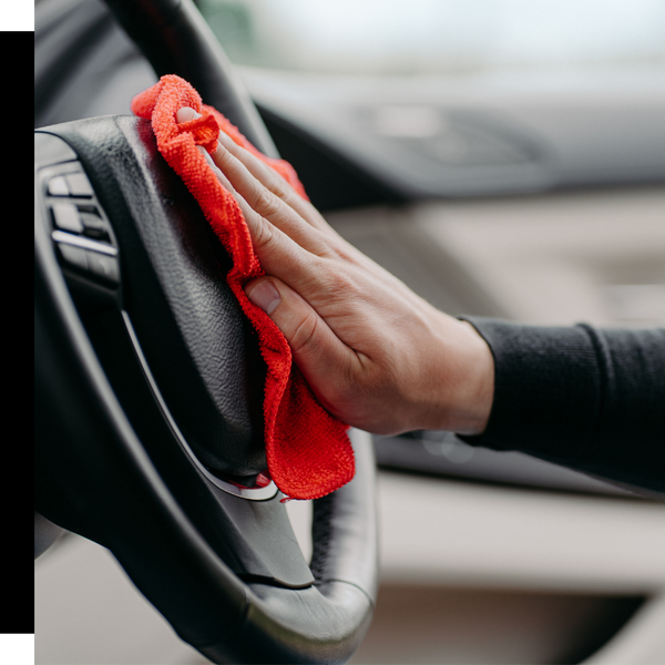 wiping steering wheel with red rag