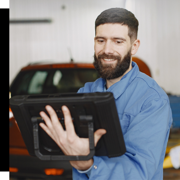 smiling technician smiling at tablet