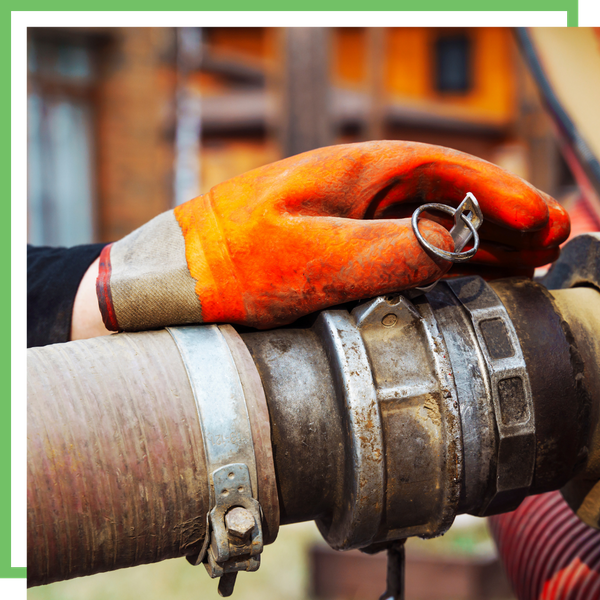 Gloved hand working a septic pump