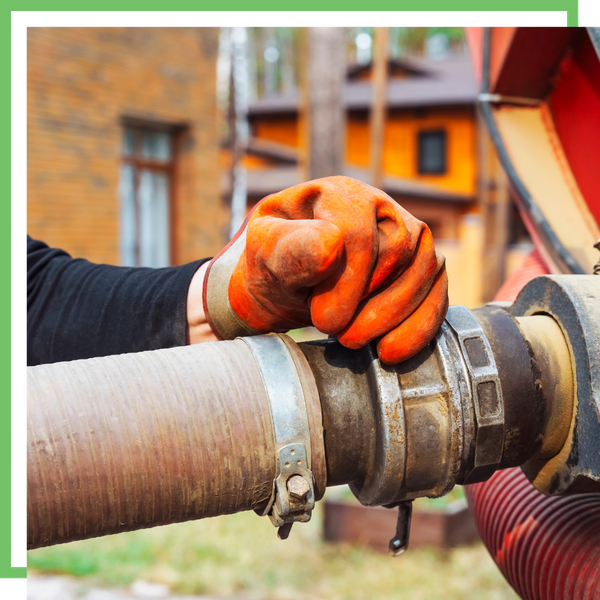 Gloved hand resting on a septic pump