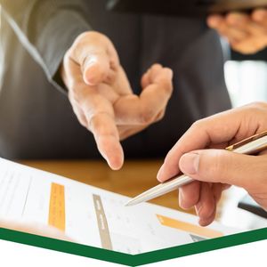 pointing at paperwork with pen