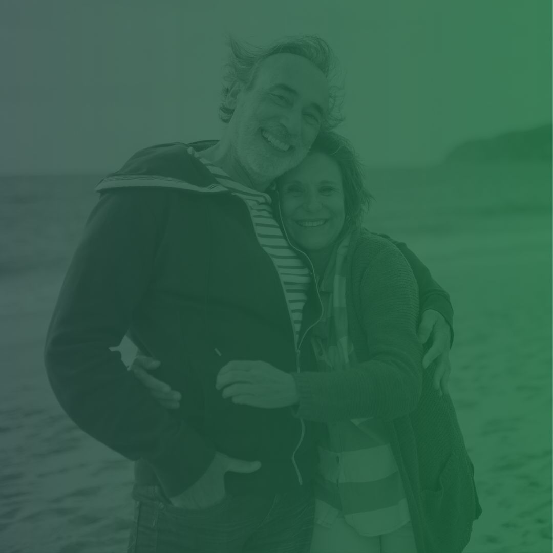 happy relaxed middle-age couple on beach