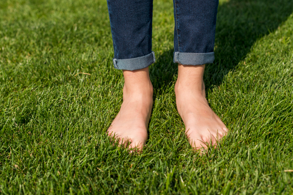 barefoot-little-girl-standing-grass-close-up.jpg
