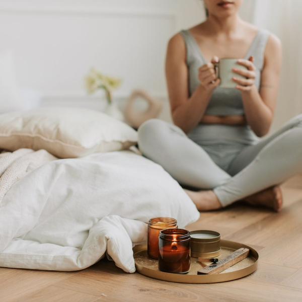 A woman at peace at home with some candle lit