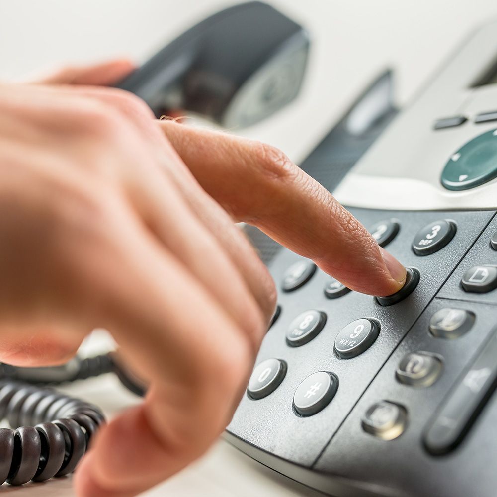 Image of a person dialing a phone