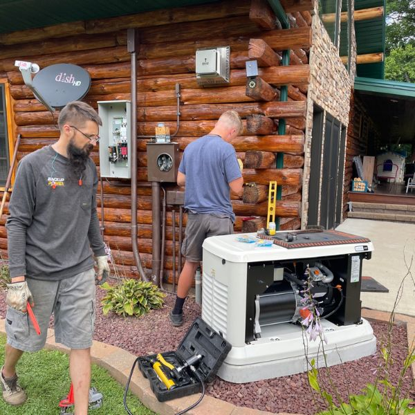 Backup Power technicians working on a generator