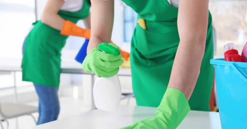 spraying tabletop surface while scrubing
