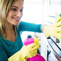 woman cleaning surface smiling