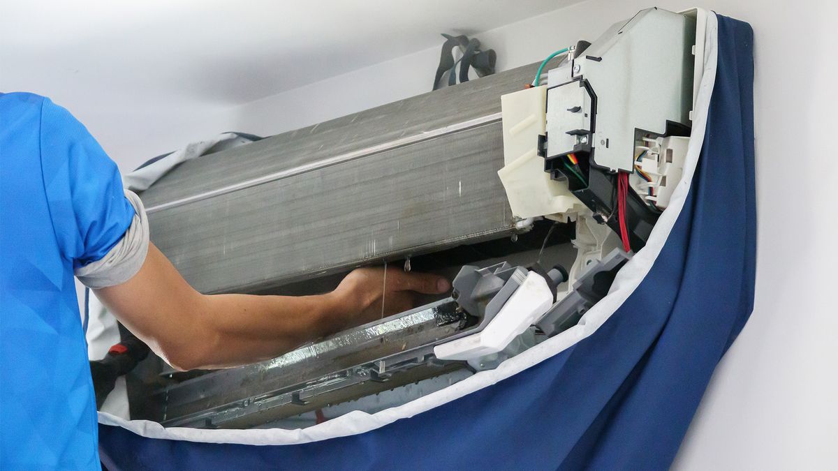 AC installation vs replacement – technician replacing an AC system