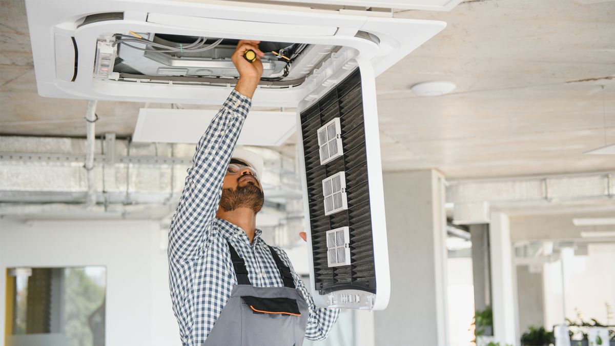 HVAC Services in Pompano Beach – Technician Repairing Air Conditioning Unit