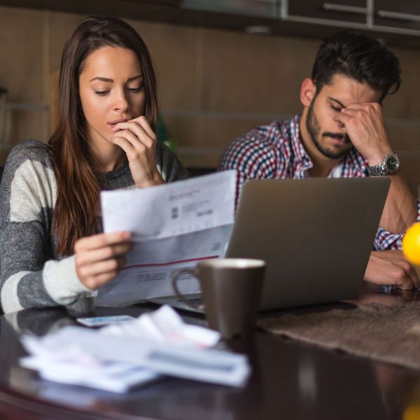 Stressed couple looks at bills