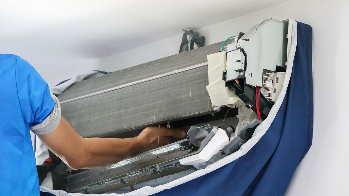 AC installation and replacement in Big Pine Key — technician servicing indoor unit