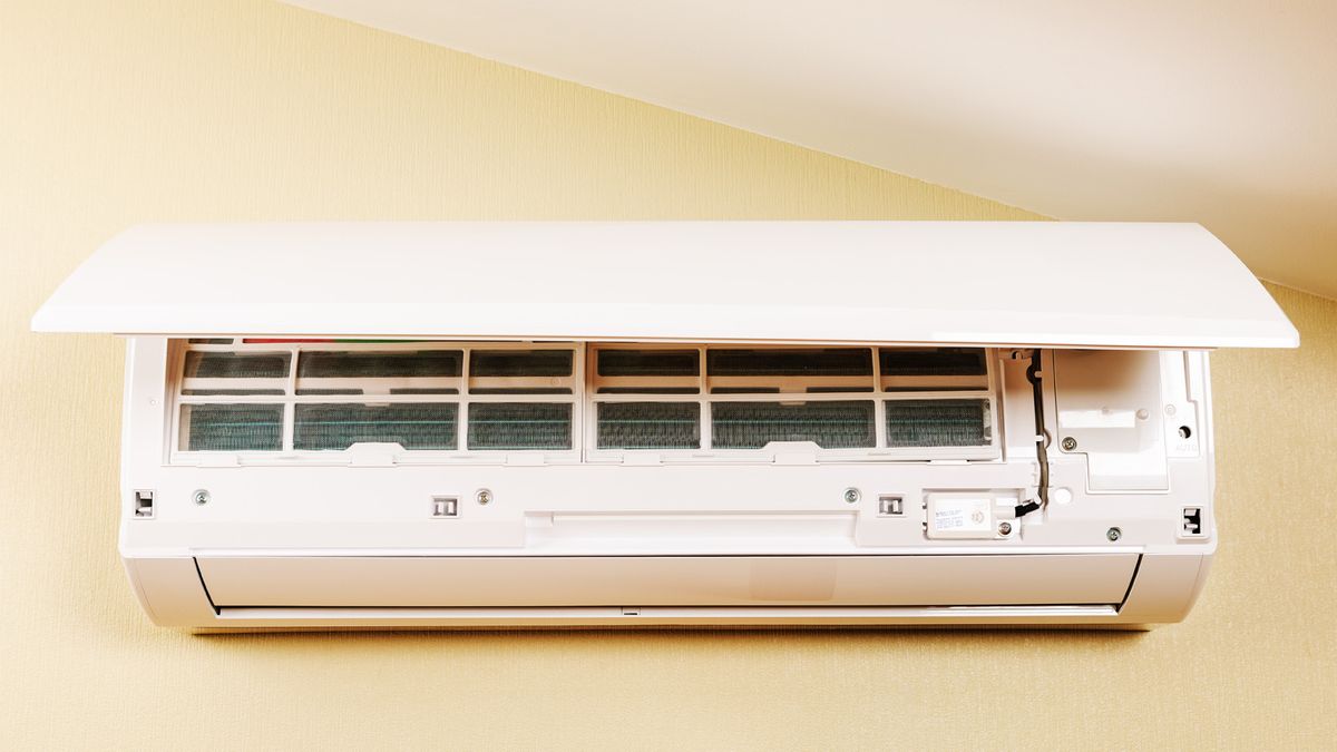 Wall-mounted split AC indoor unit with the front panel open, showing the air filters