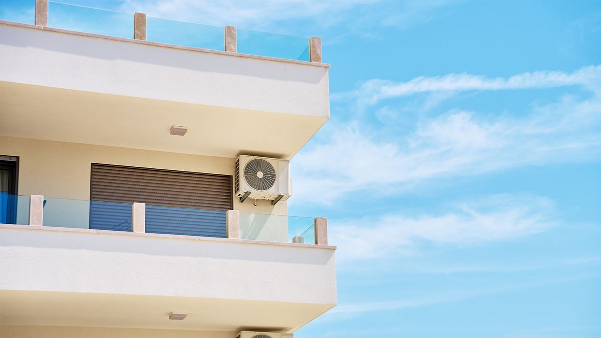 Modern residential air conditioning unit installed on apartment building exterior in Greenacres, Florida