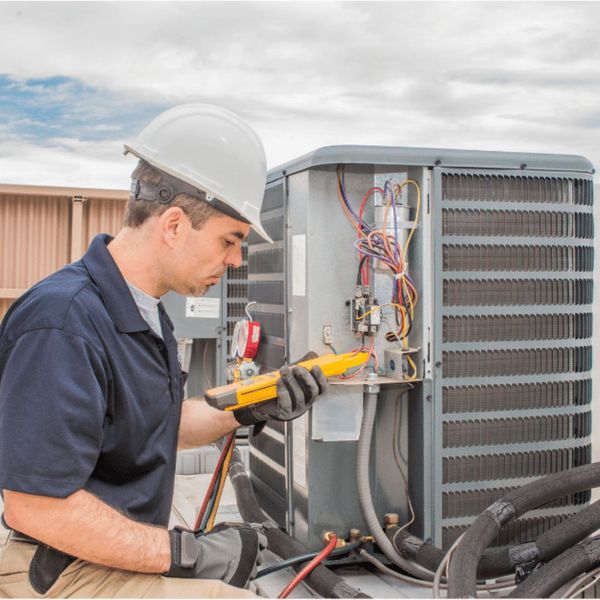 Man inspecting an AC unit. 