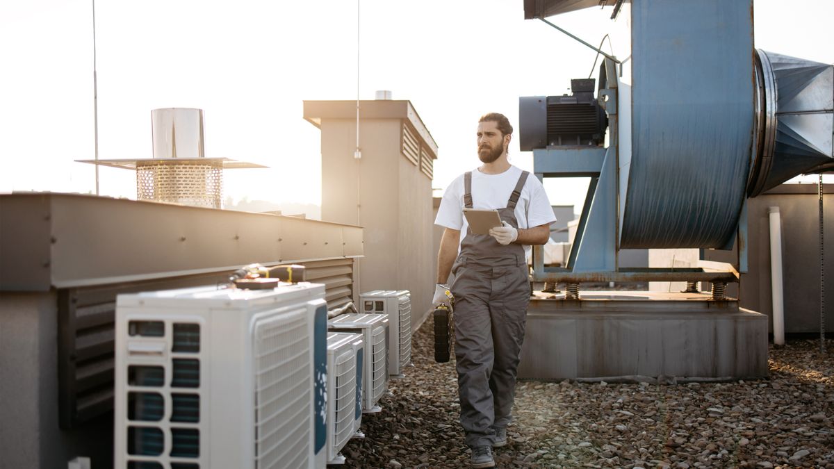HVAC technician performing AC repair on rooftop unit in South Florida