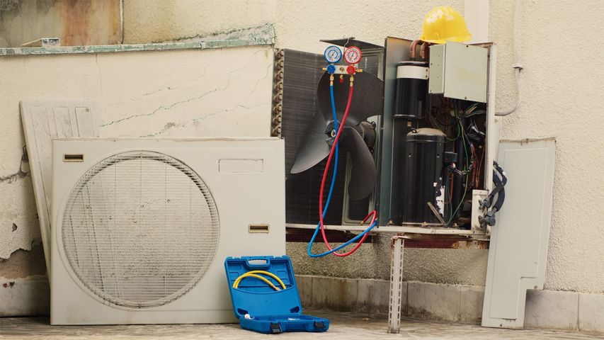AC repair in Marathon FL: HVAC technician diagnosing outdoor air conditioner issues