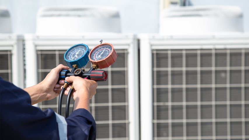 HVAC technician performing AC repair in Palm Beach County using professional diagnostic tools for reliable air conditioner repair and maintenance service Best AC Repair Palm Beach – Professional Palm Beach HVAC Company Service