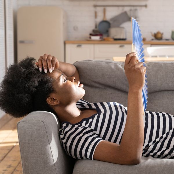 woman uncomfortably hot on couch