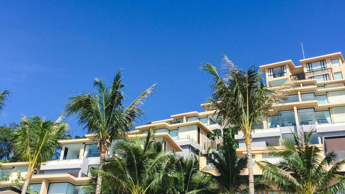 Beachfront building in Key Largo with palm trees — AC services and repair