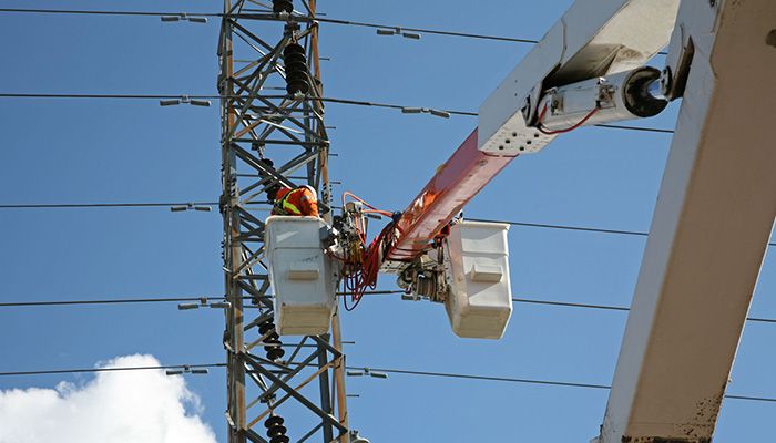 Powerline worker looking at powerline issue