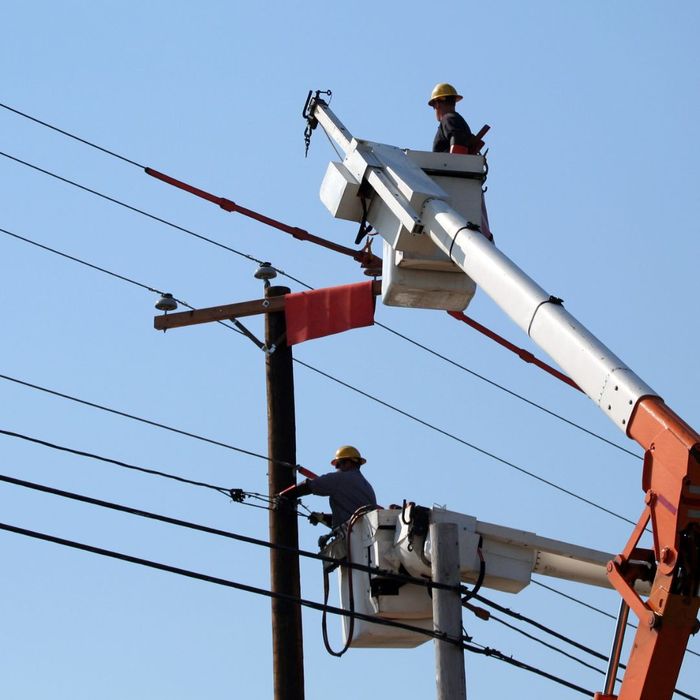 two people working on power lines