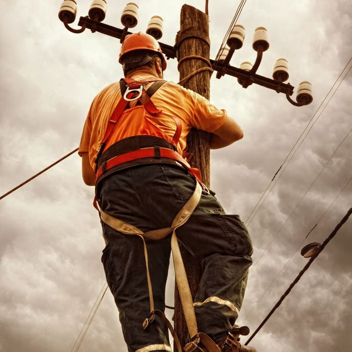 person working on power line pole