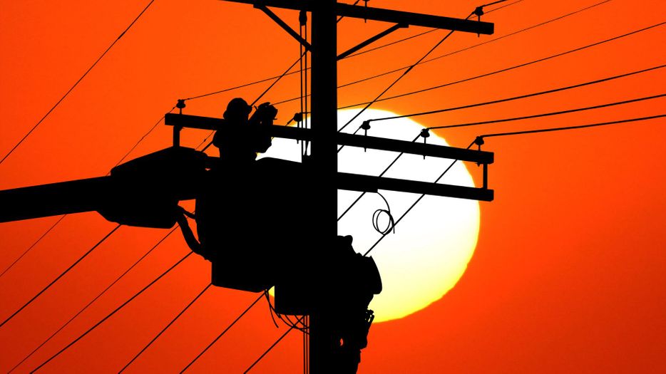 silhouette of power line worker