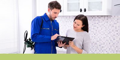 pest control worker talking with customer