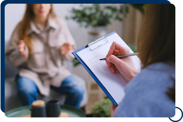 Close-up of therapist taking notes