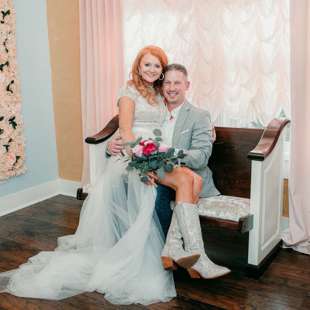 bride and groom sitting on bench