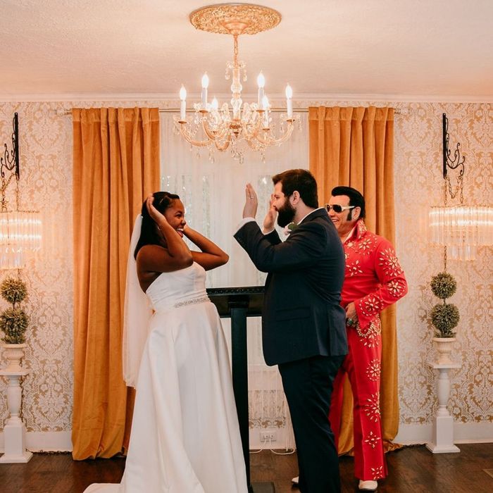 Bride and groom holding hands during a wedding ceremony officiated by an Elvis impersonator Bride and groom holding hands during a wedding ceremony officiated by an Elvis impersonator
