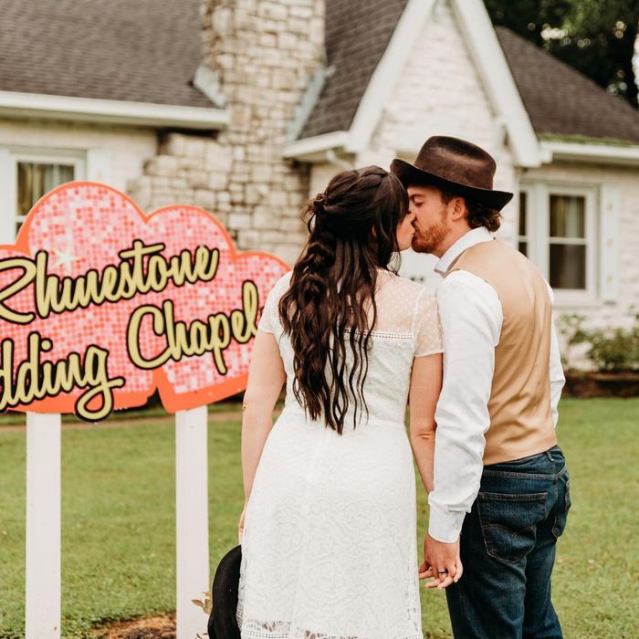 Couple kissing in front of Rhinestone Wedding Chapel sign