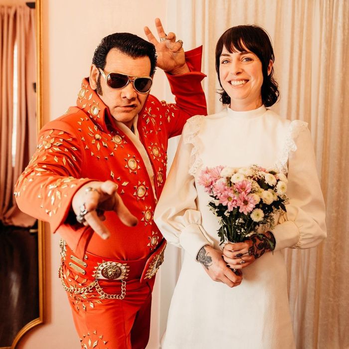 posing on wedding day with Elvis
