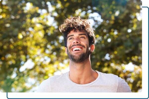 man smiling big outdoors