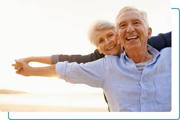 man and woman smiling outdoors