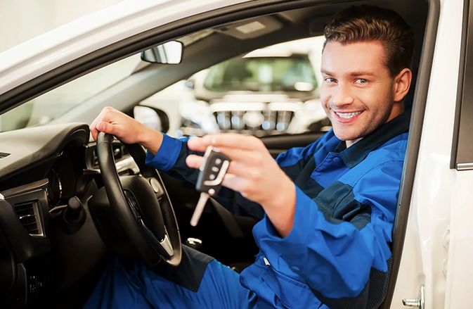 Guy in a car holding his key