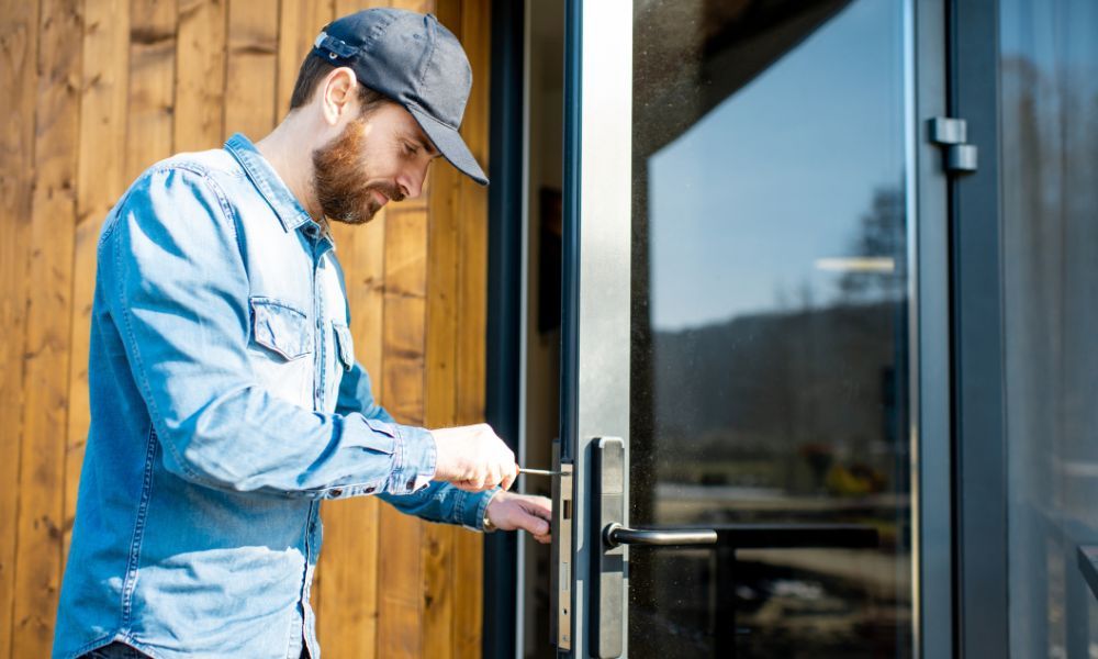 locksmith working on lock of glass door