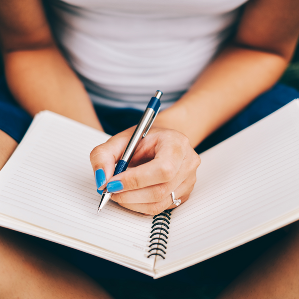 woman writing their goals