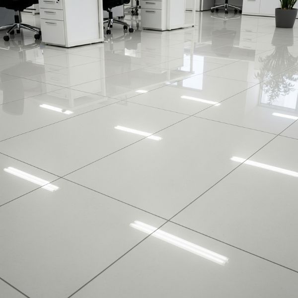 The gleaming, polished floor of a modern office hallway is completely clear and safe.