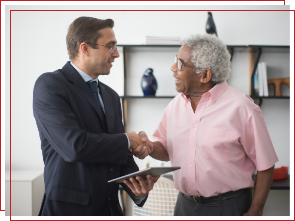 senior man shaking a businessman's hand.