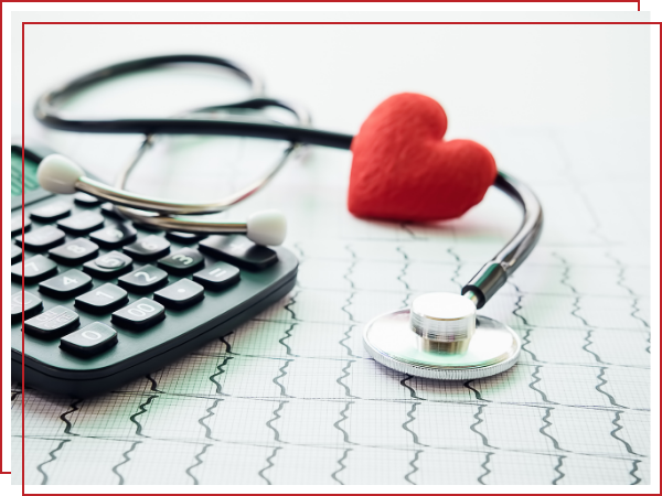 stethoscope on top of an EKG next to a calculator and a fabric heart.  