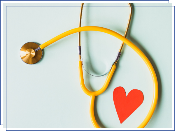 stethoscope next to a red paper heart.